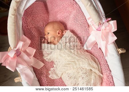 Newborn Baby Girl In Stroller Looks Surprised. Child Wrapped In Woolean Blanket, Looking Attentively