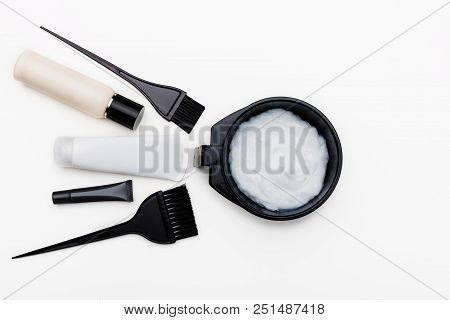 Tools For Hair Dye. Brush, Bowl And Hair Dye In Tubes Top View