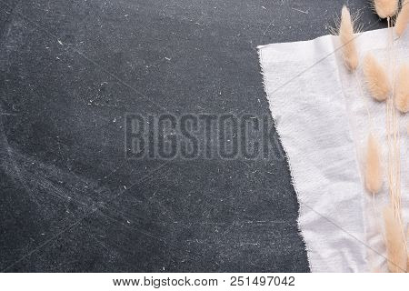 Black Background With White Fabric And Dry Flowers, Place For Text