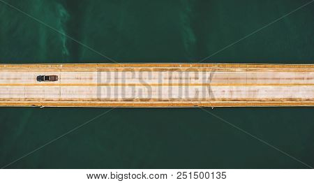 Aerial Top View Of A Long Highway Bridge Above A River.