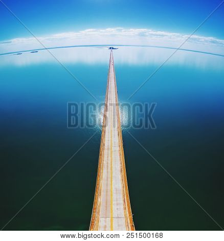 Aerial Top View Of A Long Highway Bridge Above A River.