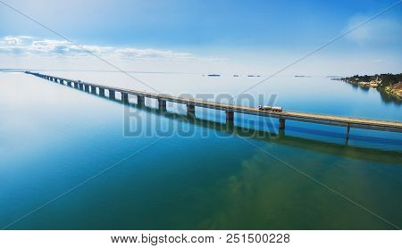 Aerial View Of A Long Highway Bridge Above A River.