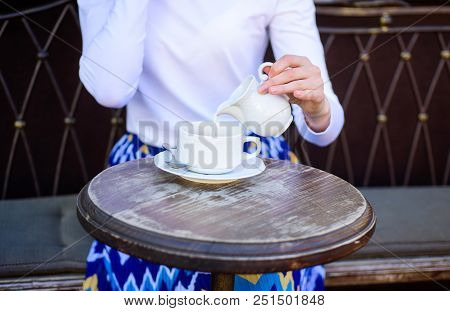 Tips For Healthier Coffee Drinking. Hand Female Adding Pouring Milk To Black Coffee Outdoors Cafe Te