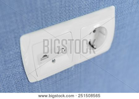 Socket On A Blue Wall, A Multifunction Outlet With An Internet Connection And European-style Outlet