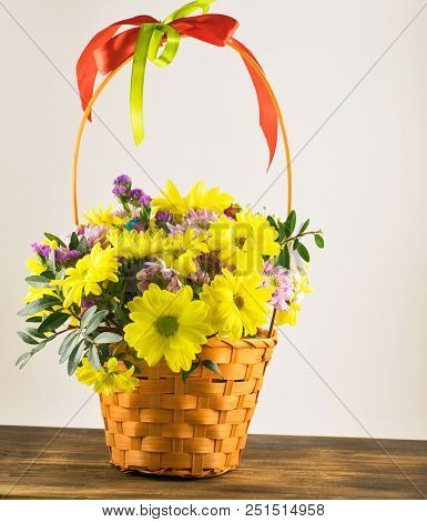 Beautiful Bouquet Of Yellow Chrysanthemums Flowers In Wicker Basket.