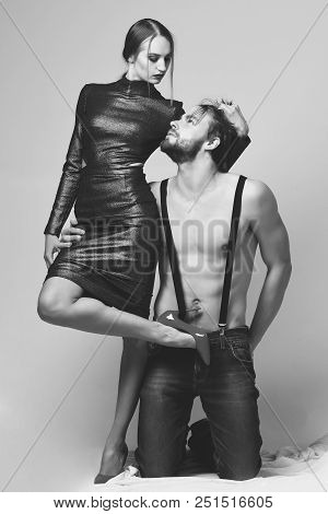 Macho Stands On Knees Near Sexi Woman In Red High Heeled Shoes. Erotica And Fashion Concept. Man And