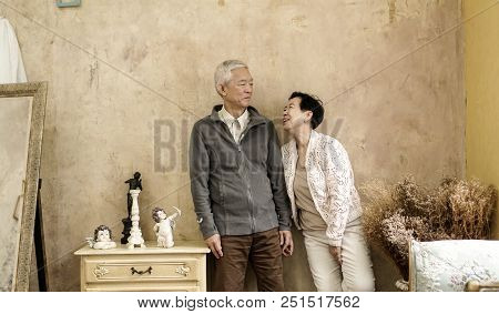 Happy Asian Senior Couple Casual Dress With Sunglasses In Vintage House