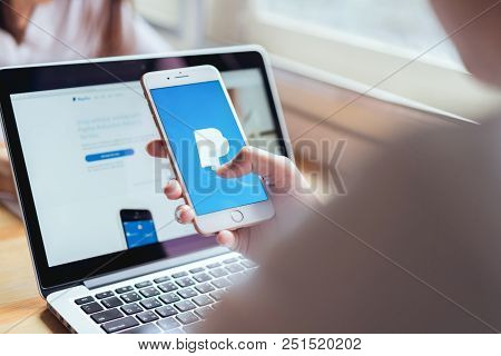 Bangkok, Thailand - July 31, 2018 : Woman Use Smartphone On The Table Showing Screen Paypal Web Page