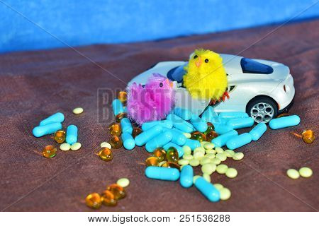 Children's White Typewriter Small Toys, Different Pills On A Brown Surface On A Blue Background. The