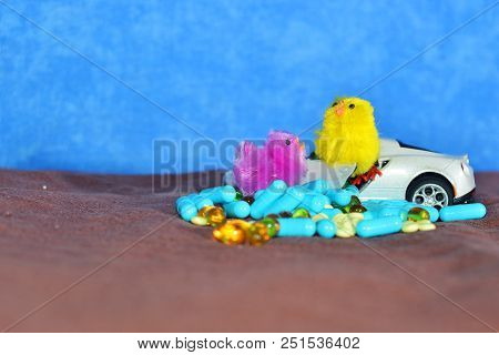 Children's White Typewriter Small Toys, Different Pills On A Brown Surface On A Blue Background. The