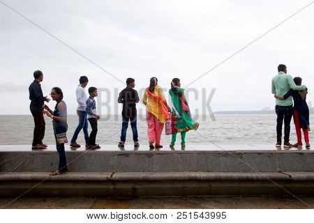 MUMBAI, INDIA - JULY 2 2018: Unidentified people visit promenade in South Mumbai. 
The promenade is an open space where people could meet friends and just spend time