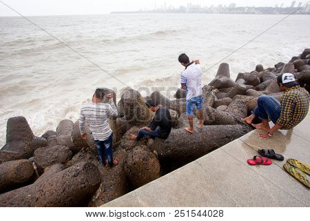 MUMBAI, INDIA - JULY 2 2018: Unidentified people visit promenade in South Mumbai. 
The promenade is an open space where people could meet friends and just spend time