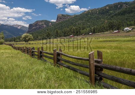 A Green And Lush Country Ranch Nestled Beneath Some Of The Rocky Peaks Of The Southern Colorado Rock