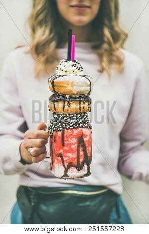 Young Woman In Light Pink Clothing Holding Summer Cold Strawberry Donut Freakshake Drink With Whippe
