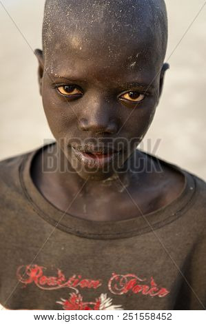 Orango Island, Guinea-bissau - February 2, 2018:  Portrait Of A Young African Boy At The Beach In Th