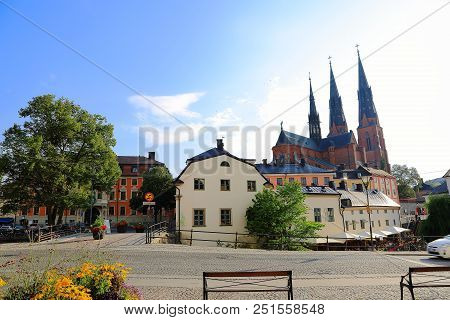 Gorgeous View On Town Street With Cathedral On Background. Gorgeous Blue Sky With White Clouds On A 