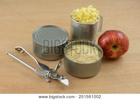Cans Of Albacore Tuna Fish, Retro Can Opener, Red Delicious Apple And Chopped Apple In Retro Vintage