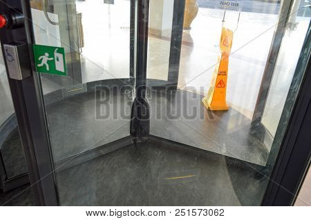 A Revolving Glass Door To The Shopping Center, A Building, A Three-door Structure Anchored On The Ce