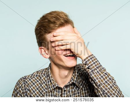 Facepalm. Happy Smiling Joyful Man Covering His Face. Shame And Fun Concept. Portrait Of A Young Guy