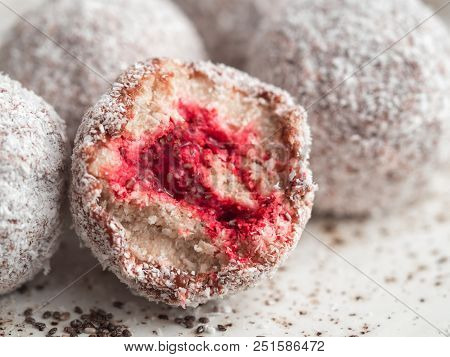 Raw Vegan Lamington Bliss Balls With Raspberries Chia Jam On Gray Background. No Baked Healthy Vegan