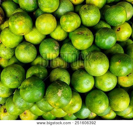 Bunch Of Vibrant Sweet Green Lemon In A Market