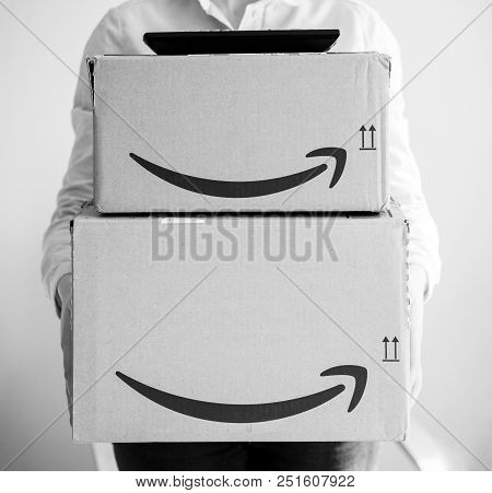 Paris, France - Mar 16, 2018: Happy Smiling Woman Holding Two Large Amazon Prime Cardboard Boxing Af