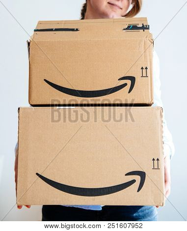 Paris, France - Mar 16, 2018: Happy Smiling Woman Holding Two Large Amazon Prime Cardboard Boxing Af