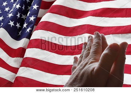 American flag and praying hands