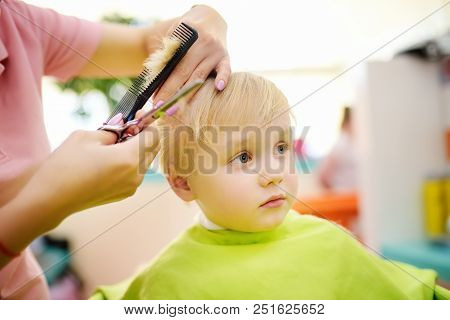 Preschooler Boy Getting Haircut. Children Hairdresser With Professional Tools - Comb And Scissors. C