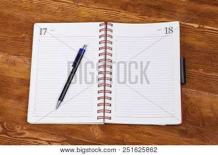 Top View Notebook With Pen On Dark Wooden Table Background