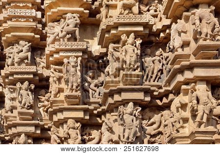 Indian Architecture With Figures Of Dancing People, Gods, Animals. Reliefs Of Historical Temple In K