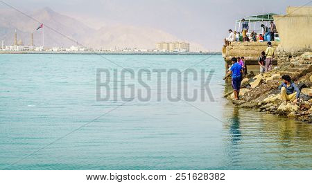 Dibba, Al Fujairah, UAE, November 25, 2016: local anglers fishing from the shore near Dibba Port, UAE