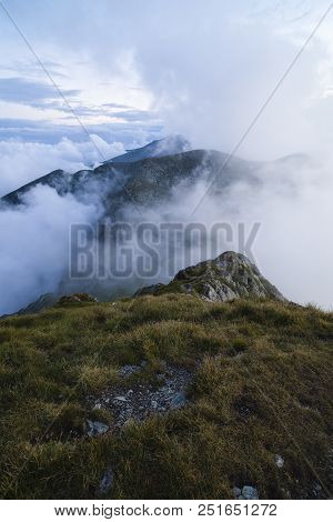 Summer Landscape With High Mountains And Clouds In A Summer Day
