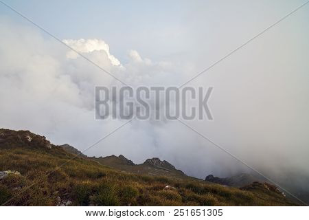 Summer Landscape With High Mountains And Clouds In A Summer Day