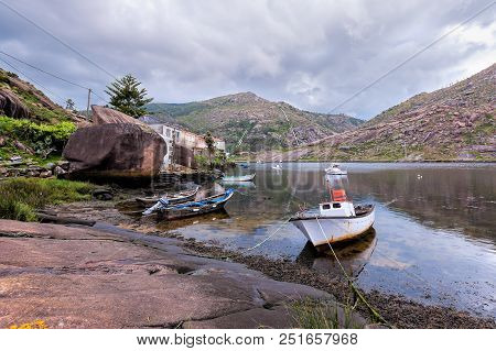 Landscape With Fishing Boats Moored  On Shore. Galicia Spain.