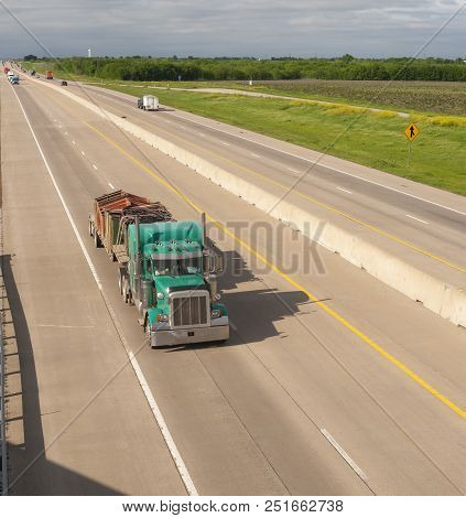 A Bright And Colorful 18 Wheeler Motors Down The Highway With Trailer Attached