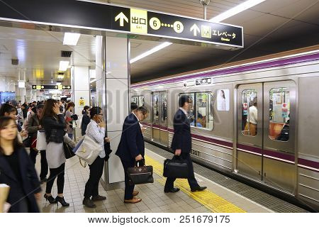 Osaka, Japan - November 22, 2016: People Board A Subway Train In Osaka Metro, Japan. Osaka Metro Has
