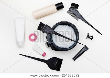 Tools For Hair Dye. Brush, Bowl And Hair Dye In Tubes Top View