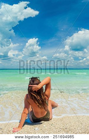woman sunbathing on the beach summer travel holidays