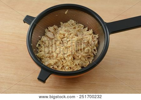 Albacore Tuna Fish Freshly Rinsed With Water And Flaked In Strainer As Food Preparation
