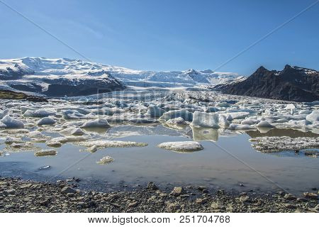 Fjallsárlón Glacier Lagoon In Southeast Iceland Showing Floating Icebergs.