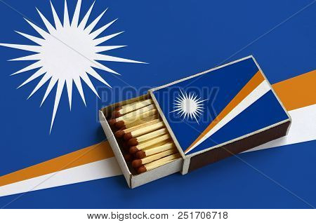 Marshall Islands Flag  Is Shown In An Open Matchbox, Which Is Filled With Matches And Lies On A Larg