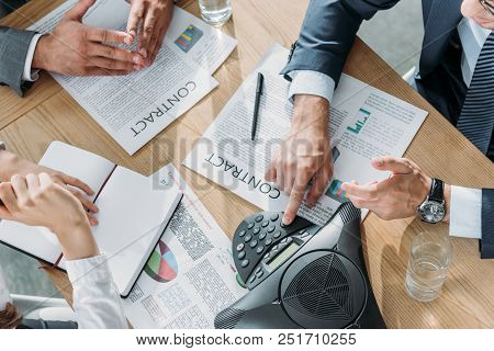 Cropped Shot Of Business People Having Conversation With Contracts And Speakerphone On Table At Mode