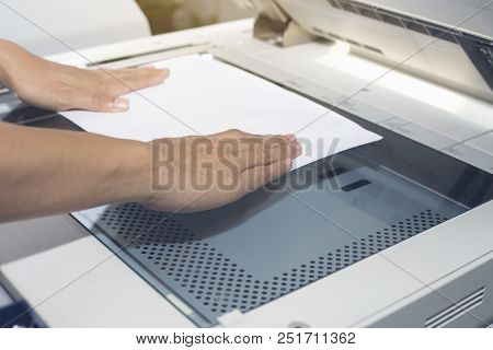 Woman Hands Putting A Sheet Of Paper Into A Copying Device