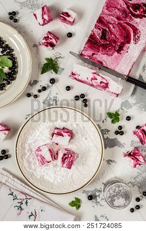 Blackcurrant Swirl Marshmallow In A Plate With Icing Sugar