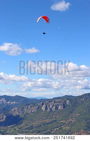 Paraglider Flying High Above The French Alps