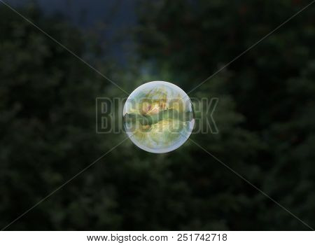 A Amazing One Colourful Bubble From Bubble Blower Flyin In The Air On Dark Background. Amazing Detai