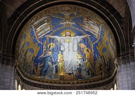 PARIS, FRANCE - JANUARY 08, 2018: Christ in Majesty is surrounded by the Virgin Mary, Joan of Arc and St. Michael, mosaic by Luc-Olivier Merson, Basilica of the Sacred Heart of Jesus in Paris.