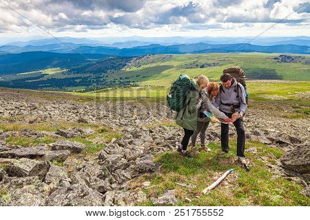 Travel Lifestyle And Survival Concept Rear View. Hiking Man And Women With Backpack Enjoys A Hike  A