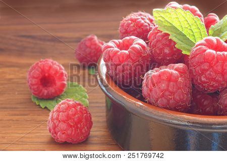 Red Rapberries Against The Light Closed Up